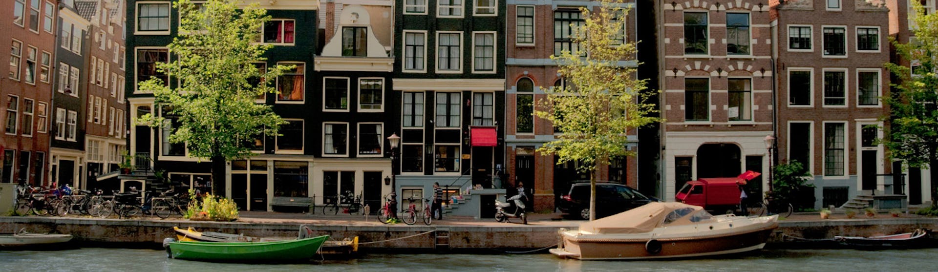 Vackra byggnader längs en kanal i Amsterdam, Nederländerna.